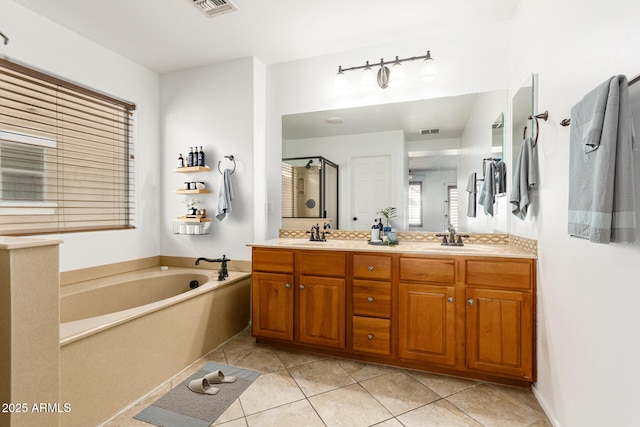 bathroom featuring tile patterned flooring, vanity, and separate shower and tub