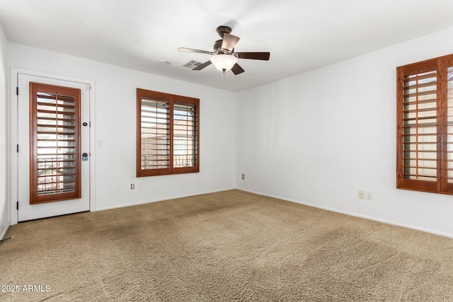 spare room with carpet and ceiling fan