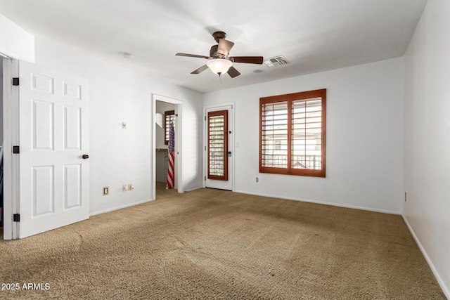 unfurnished room featuring ceiling fan and carpet floors