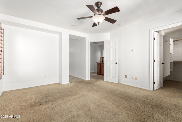 empty room featuring light colored carpet and ceiling fan