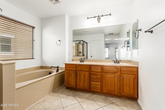 bathroom with tile patterned flooring, vanity, and independent shower and bath