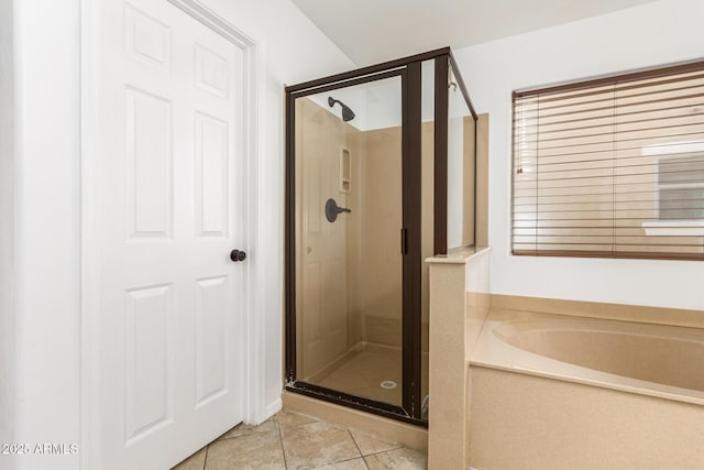 bathroom with tile patterned floors and independent shower and bath