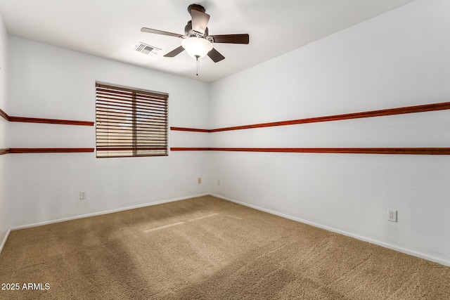 carpeted spare room with ceiling fan