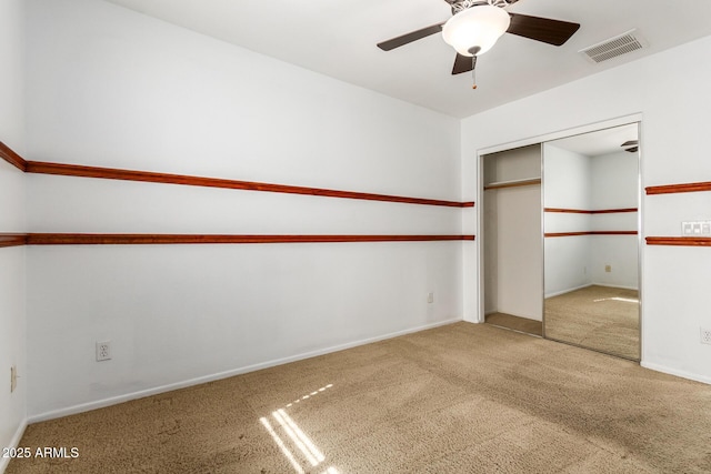 interior space with ceiling fan and carpet