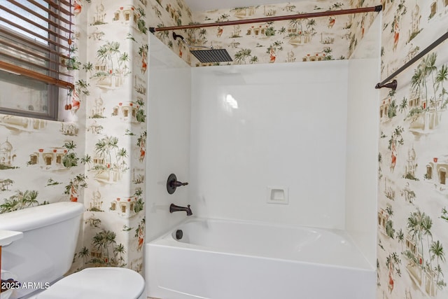 bathroom with shower / bathing tub combination and toilet