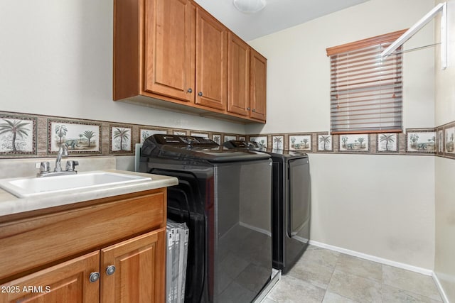 washroom featuring cabinets, light tile patterned floors, washing machine and dryer, and sink