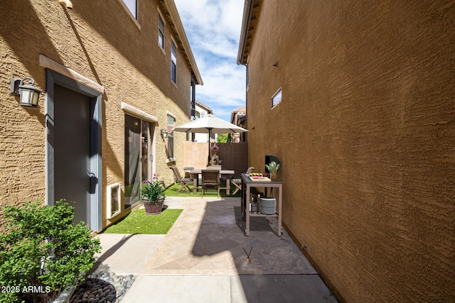 view of side of property featuring a patio