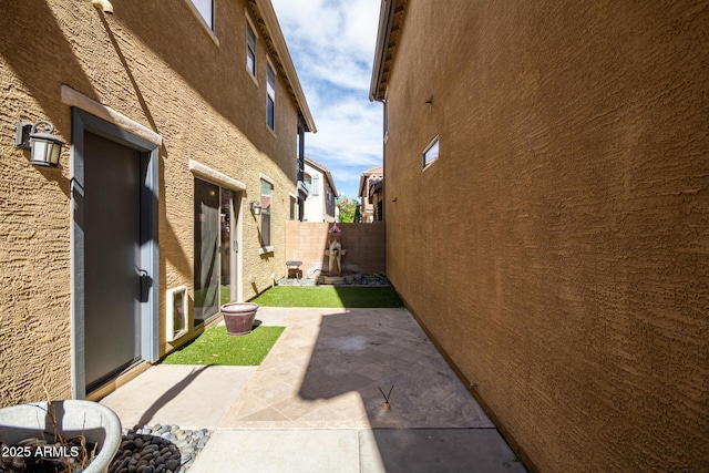 view of side of property with a patio