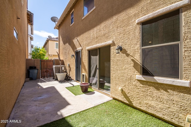 rear view of house with a patio and central air condition unit