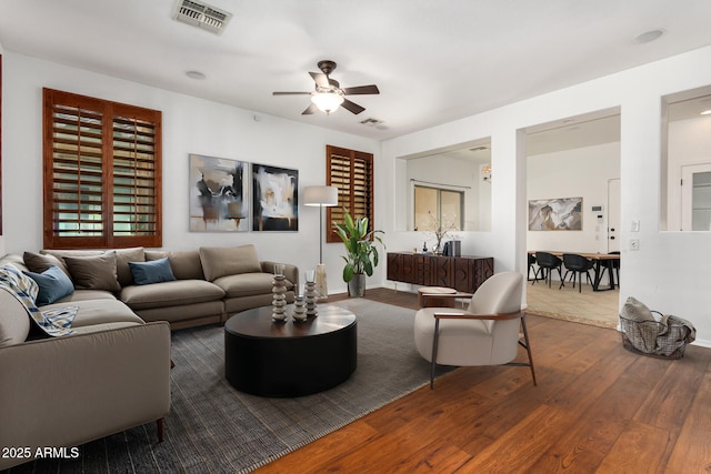 living room with ceiling fan and wood-type flooring