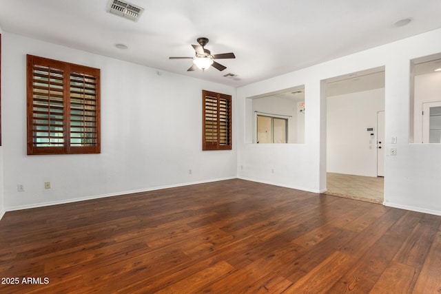 spare room featuring ceiling fan and dark hardwood / wood-style flooring