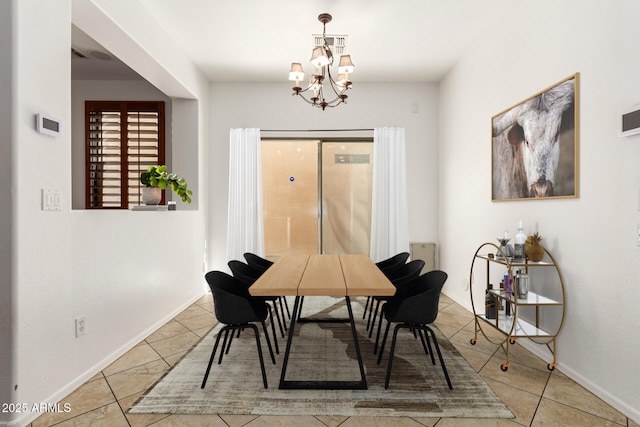 dining room featuring tile patterned flooring and a chandelier