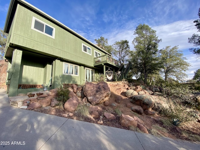 view of side of home with a deck