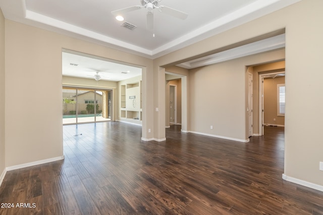 unfurnished room with ceiling fan and dark hardwood / wood-style flooring