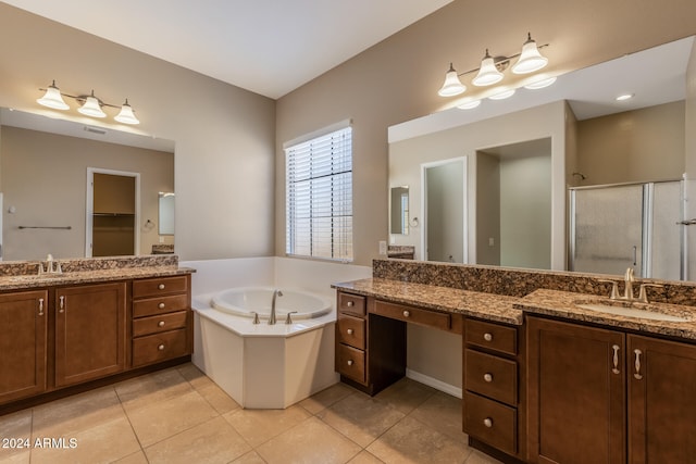 bathroom featuring tile patterned flooring, vanity, and shower with separate bathtub