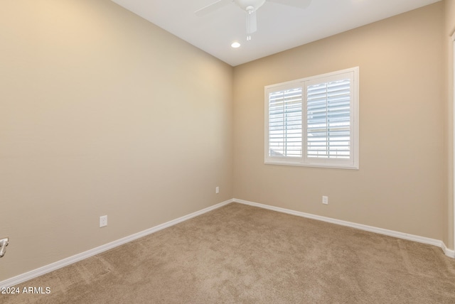 carpeted empty room featuring ceiling fan