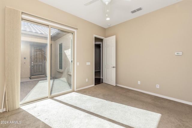 unfurnished bedroom featuring ceiling fan, light carpet, and a closet