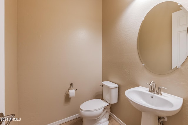 bathroom with tile patterned floors, toilet, and sink