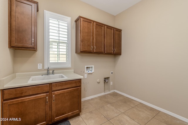 clothes washing area featuring hookup for a washing machine, electric dryer hookup, a healthy amount of sunlight, and sink