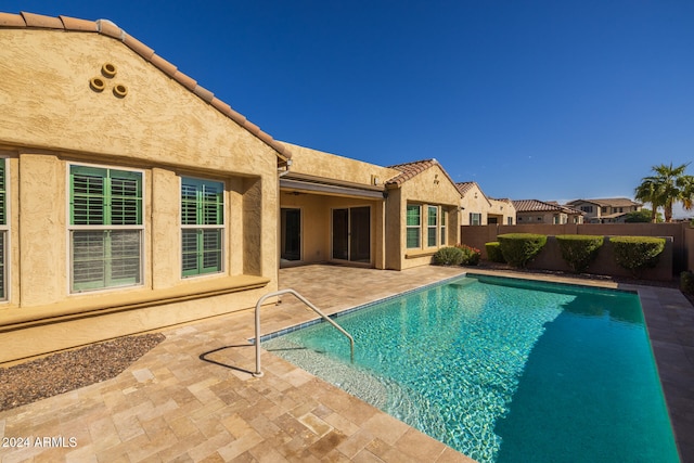 view of swimming pool featuring a patio area