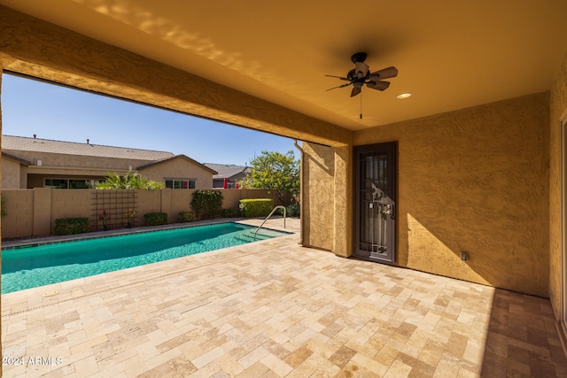 view of pool with a patio area and ceiling fan