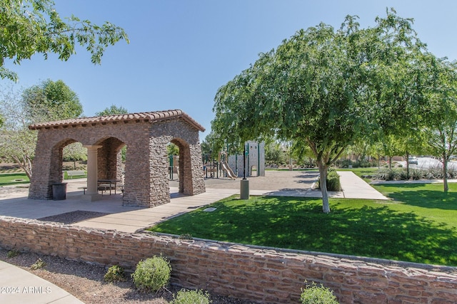 view of property's community featuring a yard and a playground