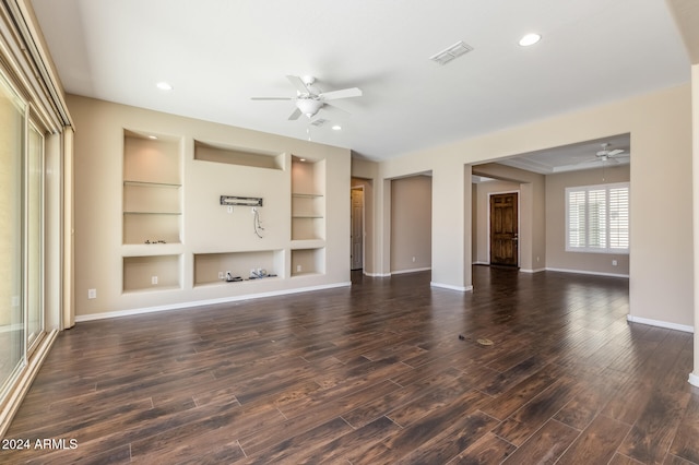 unfurnished living room featuring ceiling fan, built in features, and dark wood-type flooring