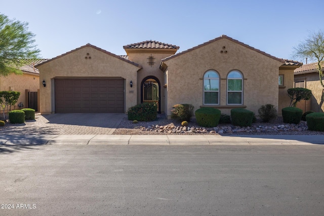 mediterranean / spanish home featuring a garage