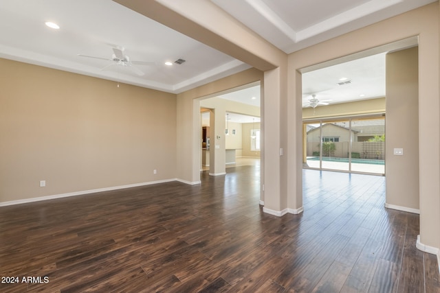 empty room featuring ceiling fan and dark hardwood / wood-style floors