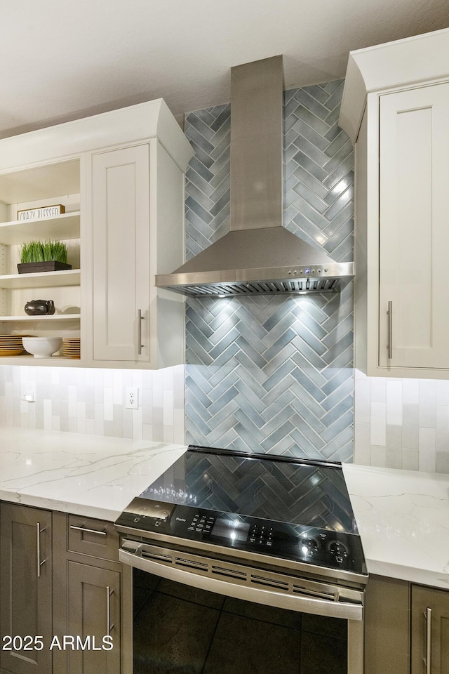 4524 E Narrowleaf Dr, Gilbert, AZ 85298 - kitchen with stainless steel range with electric stovetop, wall chimney exhaust hood, tasteful backsplash, open shelves, and light stone counters