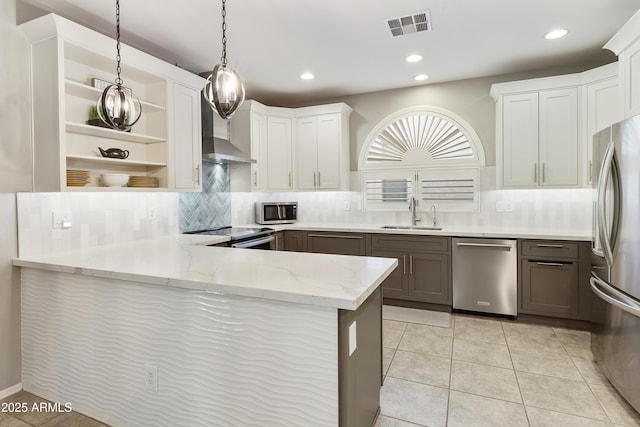 4524 E Narrowleaf Dr, Gilbert, AZ 85298 - kitchen featuring stainless steel appliances, open shelves, wall chimney range hood, backsplash, and light stone counters