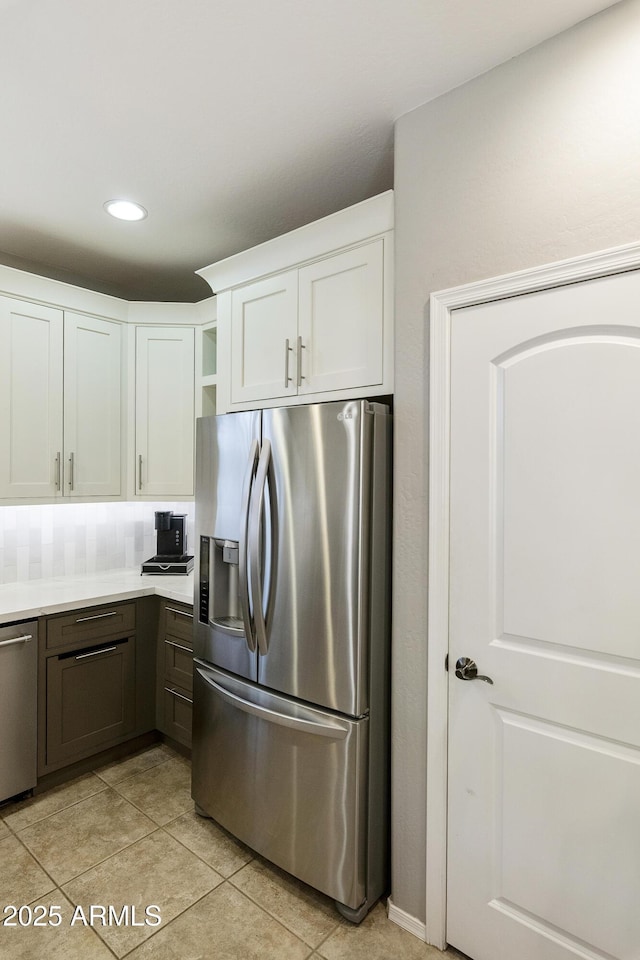 4524 E Narrowleaf Dr, Gilbert, AZ 85298 - kitchen featuring stainless steel appliances, white cabinetry, light tile patterned floors, light countertops, and tasteful backsplash