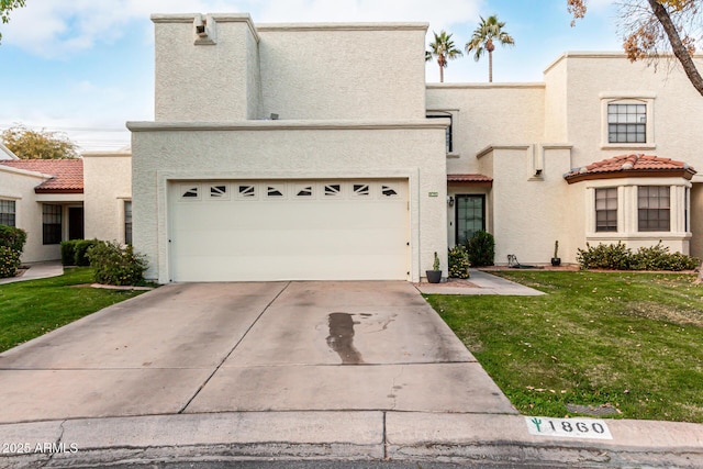 view of front of home with a garage and a front lawn