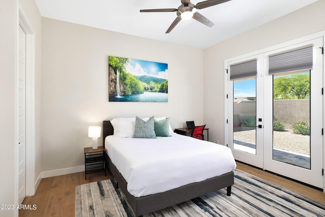 bedroom featuring access to exterior, baseboards, light wood finished floors, and a ceiling fan