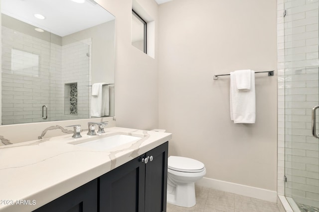 full bathroom with a stall shower, toilet, vanity, and baseboards