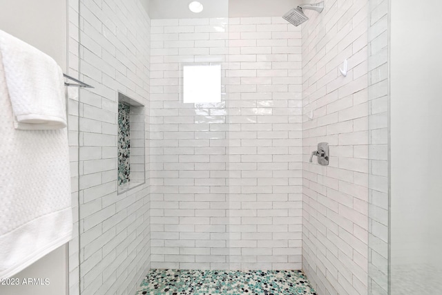 bathroom with tiled shower