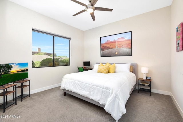 bedroom with a ceiling fan, carpet flooring, and baseboards