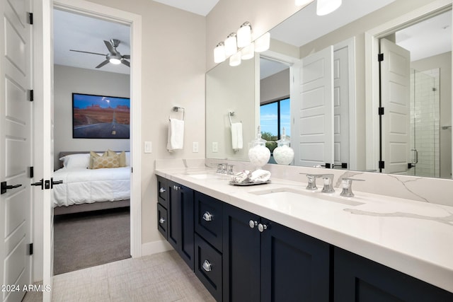 ensuite bathroom featuring double vanity, ensuite bath, ceiling fan, and a sink