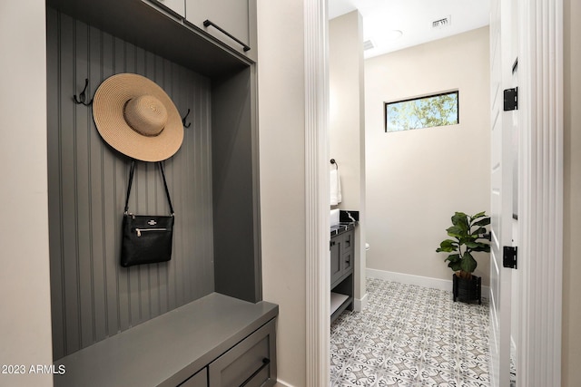 mudroom with baseboards and visible vents