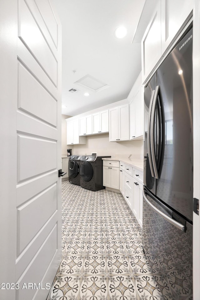 laundry room with light tile patterned floors, recessed lighting, separate washer and dryer, cabinet space, and attic access