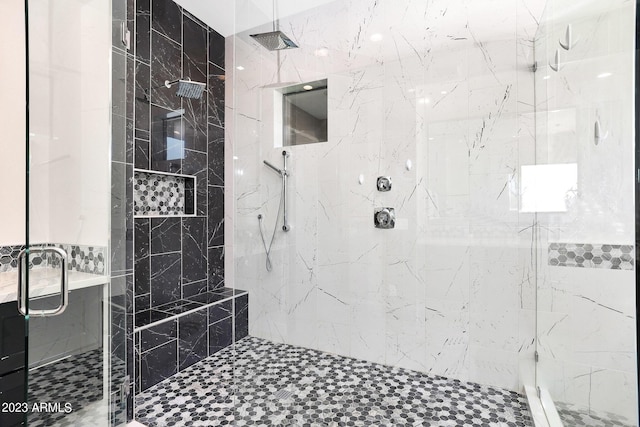 bathroom featuring a marble finish shower