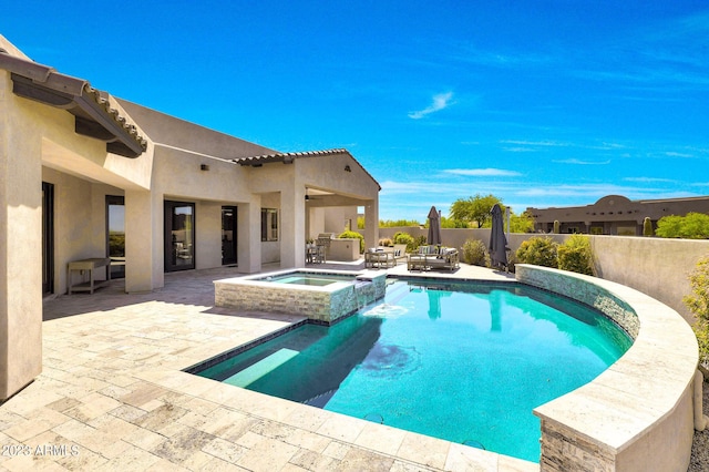 view of swimming pool featuring a patio area, a fenced backyard, and a pool with connected hot tub