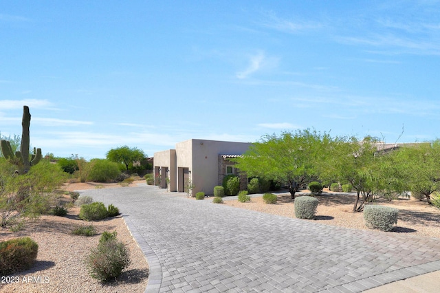 exterior space featuring decorative driveway