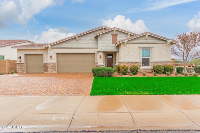 craftsman-style house with a front lawn and a garage