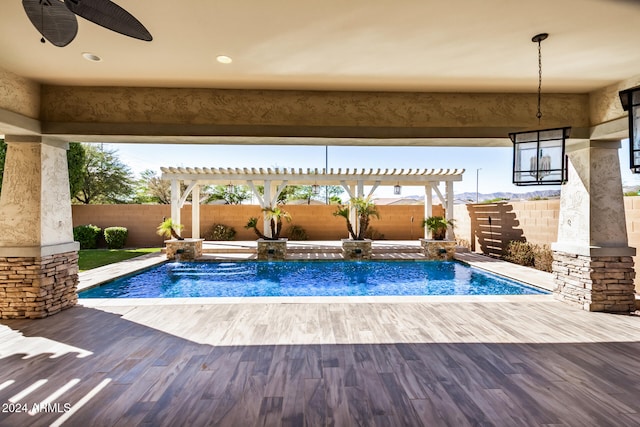 view of swimming pool with a patio, a pergola, pool water feature, and ceiling fan