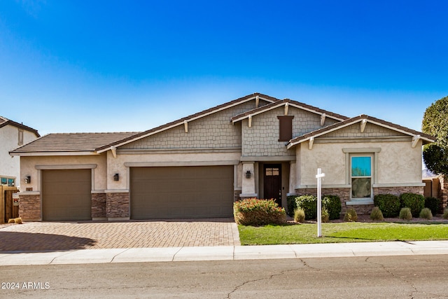 craftsman-style house featuring a garage and a front yard