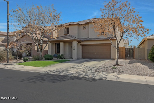 view of front of house with a gate, fence, driveway, and stucco siding