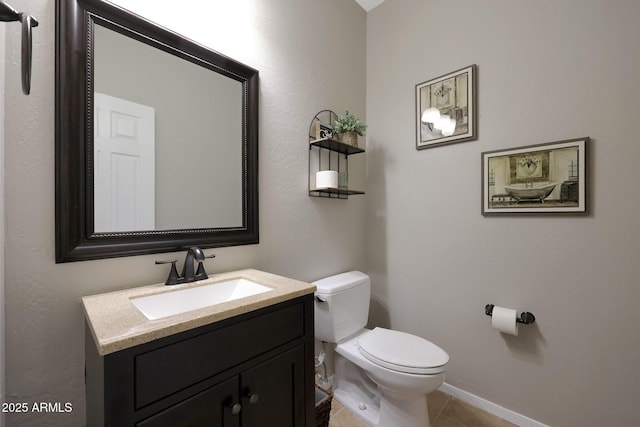 half bath featuring baseboards, vanity, toilet, and tile patterned floors