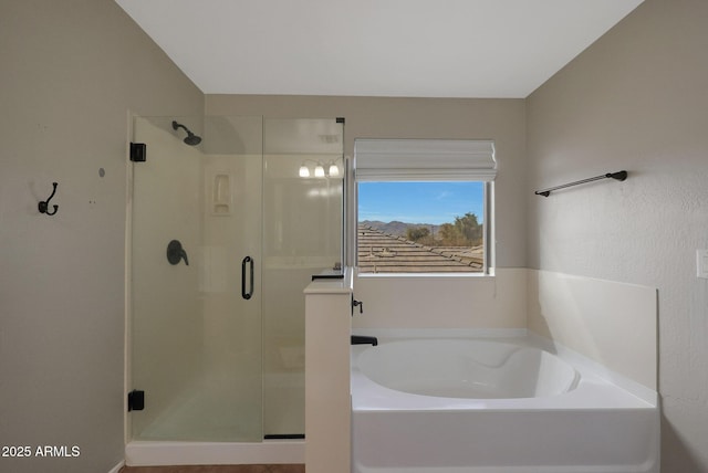 full bathroom with a stall shower and a bath