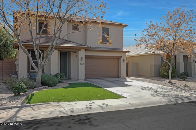 traditional-style house featuring a garage, driveway, a tiled roof, and stucco siding